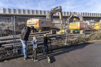 Spectators, teethers during the demolition of the 120 meter long motorway bridge of the A516,