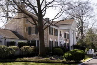 The famous Graceland estate surrounded by trees and well-kept gardens, Memphis, Tennessee, USA