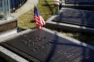 Engraved grave slabs of Elvis Presley with an American flag, Memphis, Tennessee, USA