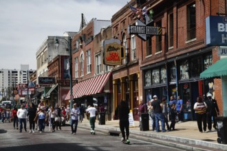 Bustling Beale Street with strollers and shops in Memphis, Memphis, Tennessee, USA