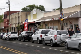 Bustling main street in Mamou with parked cars and buildings, Mamou, Louisiana, USA