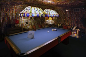 Billiard room with blue table and bright strip lights, cozy atmosphere in Graceland, Memphis,