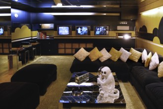 Stylish living room with plenty of pillows and television sets, in Graceland, Memphis, Tennessee,