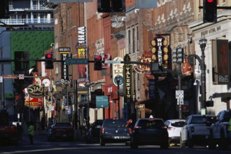 Cars drive along a busy Broadway street, Nashville, Tennessee, USA