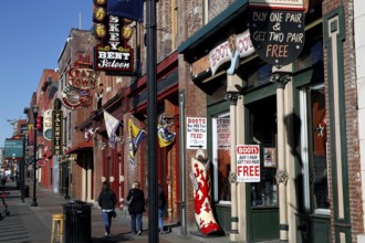 People walking along Broadway Street in daylight, Nashville, Tennessee, USA
