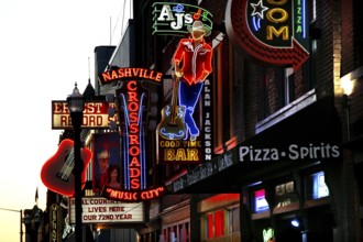 Neon lights and signs illuminate Broadway Street, Nashville, Tennessee, USA