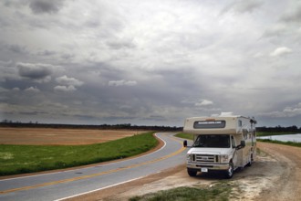 Motorhome on a winding country road under cloudy sky in Mississippi, Mississippi, zero, USA