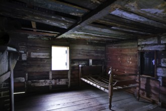 Wooden interior of a slave shelter with light coming through a window, Charleston, South Carolina,