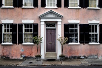 Pink-painted historic house with multiple windows in Charleston, Charleston, South Carolina, USA