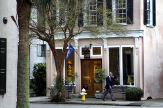 Elegant building with large windows and trees in front of it on a street in Charleston, Charleston,