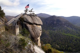 Chimney Rock with American flag and panoramic views of the forested mountains, zero