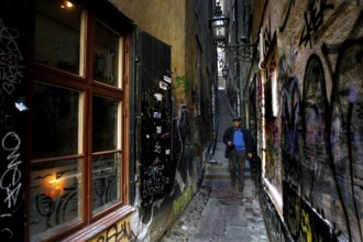 Narrowest alley in Gamla Stan with colorful graffiti and historic charm, Stockholm, Gamla Stan,