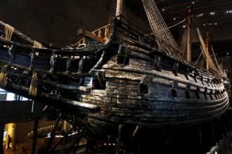 The royal flagship Vasa in the Vasa Museum presents its impressive wooden structure in low light,