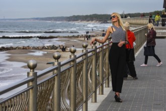Woman posing fashionably on the beach promenade in Cranz, Zelenogradsk, Cranz, Russia