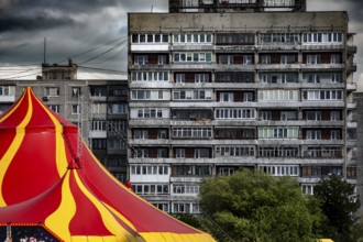An eye-catching circus tent stands in front of a dominating prefabricated building, Kaliningrad,
