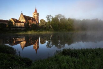 St. George's Church is picturesquely reflected in the quiet mill pond, Pravdinsk, Kaliningrad,