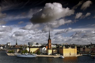 View of Riddarholmen in Stockholm with distinctive church tower and dramatic sky seen from