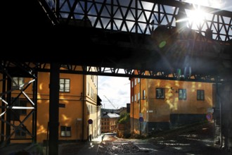 Bright buildings in Södermalm, Stockholm, in sunlight under a bridge, Stockholm, Södermanland,