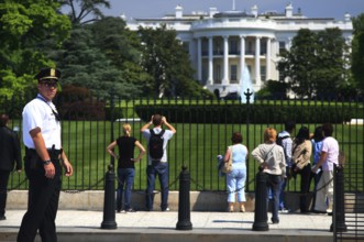 Visitors view the White House from a public area, Washington D.C, USA
