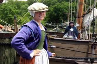Woman in historic costume standing in a harbor in Jamestown Settlement, Jamestown, Virginia, USA