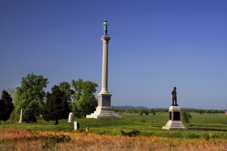 Several monuments stand in an open area of Gettysburg National Military Park, Gettysburg,