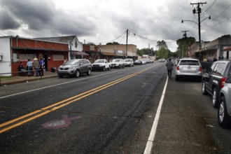 Busy main street with shops and parked cars in Mamou, Mamou, Louisiana, USA