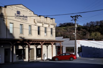 City scene with historic buildings and a red car in Lynchburg, Lynchburg, Tennessee, USA