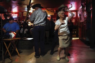 An elderly dancer dances in Fred's Lounge, Mamou, Louisiana, USA