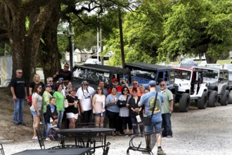 Group of visitors in front of vehicles at the McIlhenny Tabasco factory on Avery Island, Avery