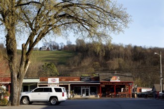 A rural road with shops and trees near Lynchburg, Lynchburg, Tennessee, USA