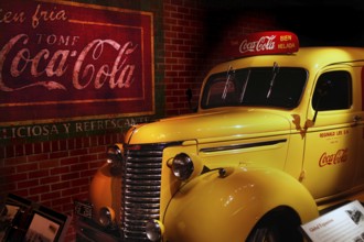 A retro yellow Coca-Cola car is presented nostalgically at the museum in Atlanta, Atlanta, Georgia,
