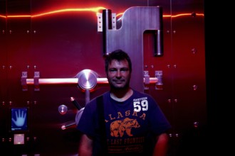A man stands in front of a futuristic illuminated safe in the Coca-Cola Museum in Atlanta, Atlanta,