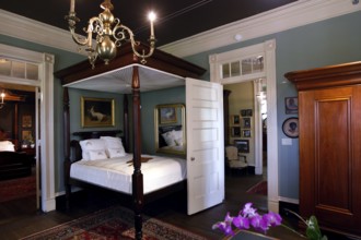 Classic bedroom with canopy bed and antique furniture, zero