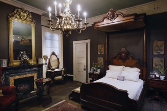 Classy bedroom with antique bed and sumptuous chandelier, zero