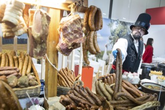 An exhibitor presents sausages from Poland at the Green Week at the exhibition center in Berlin on