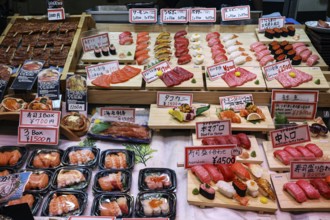 Different types of sushi presented at a market stand in Nishiki Market, Kyoto, Japan