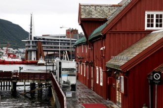 Red wooden houses by the water in Tromsø city center, Tromsø, Troms, Norway
