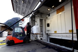Hurtigruten ship in Øksfjord loading via a cargo hatch