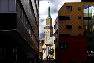 View of the cathedral between modern buildings in Tromsø, Tromsø, Troms, Norway