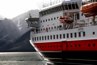 Close-up of a Hurtigruten ship next to the coastline of Øksfjord, Øksfjord, Norway