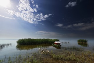 Sunset on the Curonian Spit in Vente with calm water and clouds, Vente, Lithuania