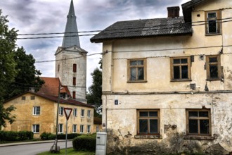 View of a church tower and old buildings under cloudy sky, Dundaga, Latvia