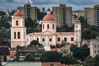 Church with red domes in front of modern residential buildings in Vilnius, Vilnius, Lithuania