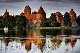 The medieval Trakai Castle is reflected in the calm water of the lake, Trakai, Lithuania