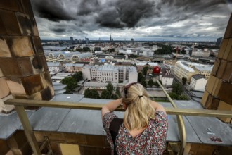 View from the Academy of Sciences over the city of Riga with a thoughtful woman in the foreground,