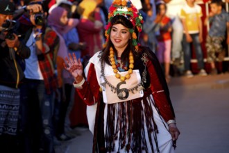 Woman in festive dress parading during the Fête des Roses, El Kelâa m'Gouna, Marrakesh-Safi,