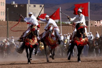 Riders in traditional clothing perform at Fantasia during the Fête des Roses, El Kelâa m'Gouna,