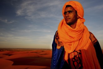 Bedouins in traditional clothing in front of the dunes of Erg Chebbi, Erg Chebbi, Morocco
