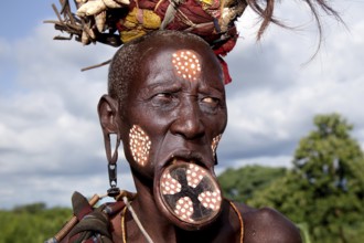 Mursi woman with lip plate and artistic face painting, Mago National Park, Ethiopia