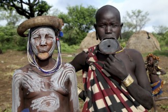 Two Mursi woman, one with lip plate, one with body painting, in Mago National Park, Ethiopia